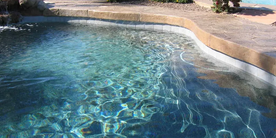 Freeform pool with a rock edge and new interior finish