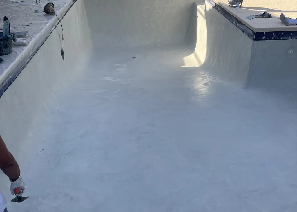 Freshly plastered pool inside a screen enclosure