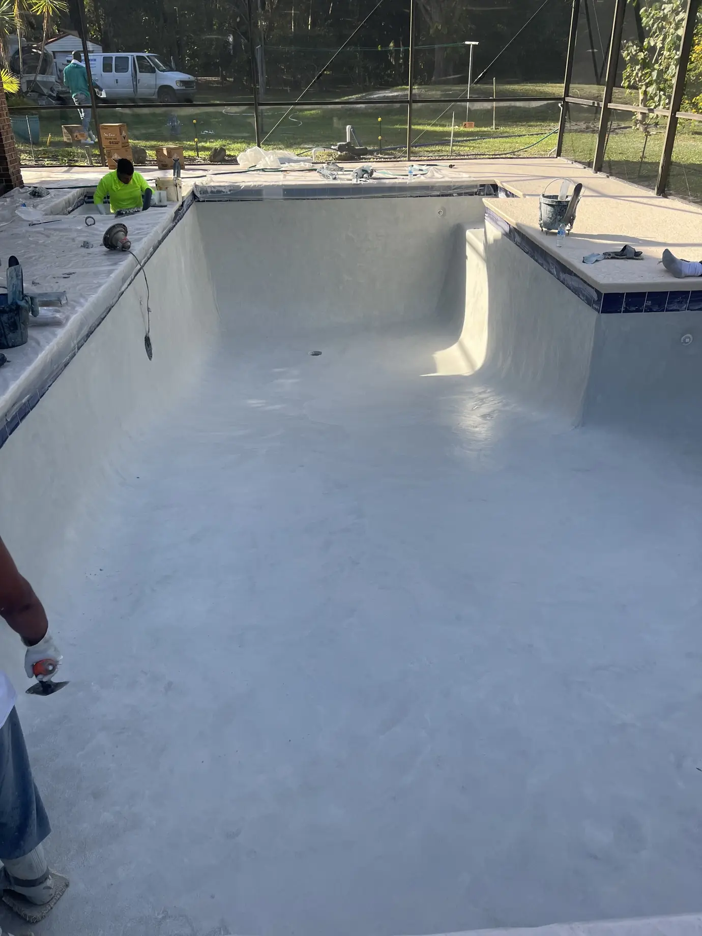 Freshly plastered pool inside a screen enclosure