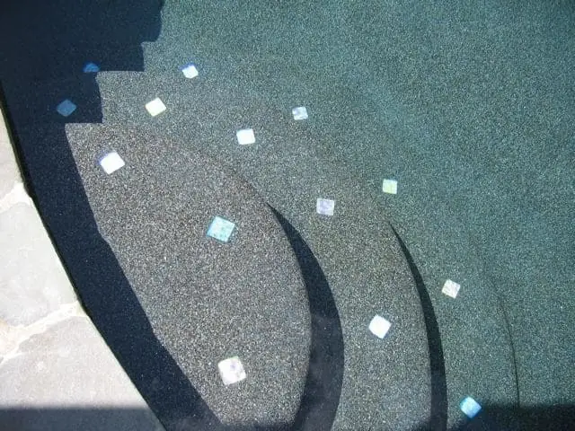 Pebble finish pool steps with small accent tiles