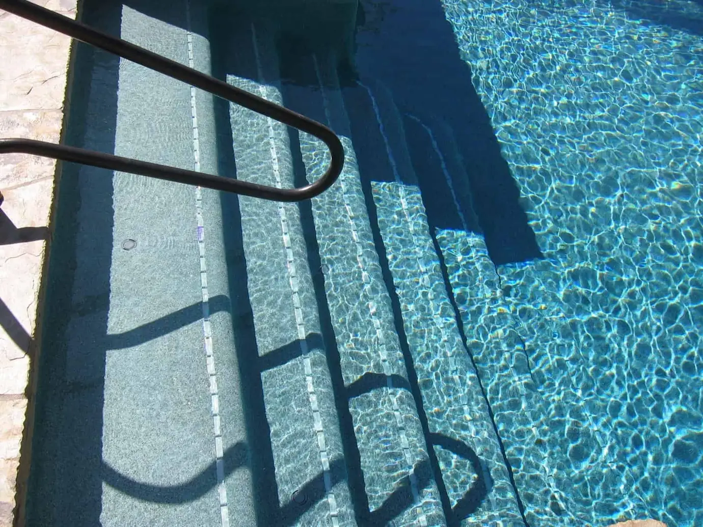 Pool steps with a handrail and blue interior finish