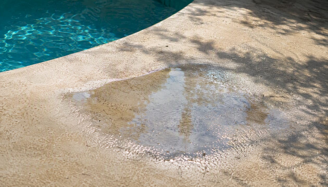 Puddle on uneven pool deck surface