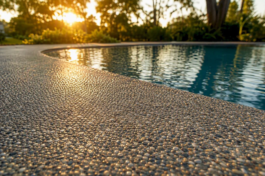 Textured pebble aggregate pool surface close-up