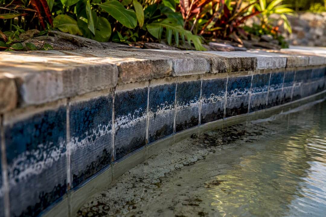 Mineral deposits forming on pool tile grout lines