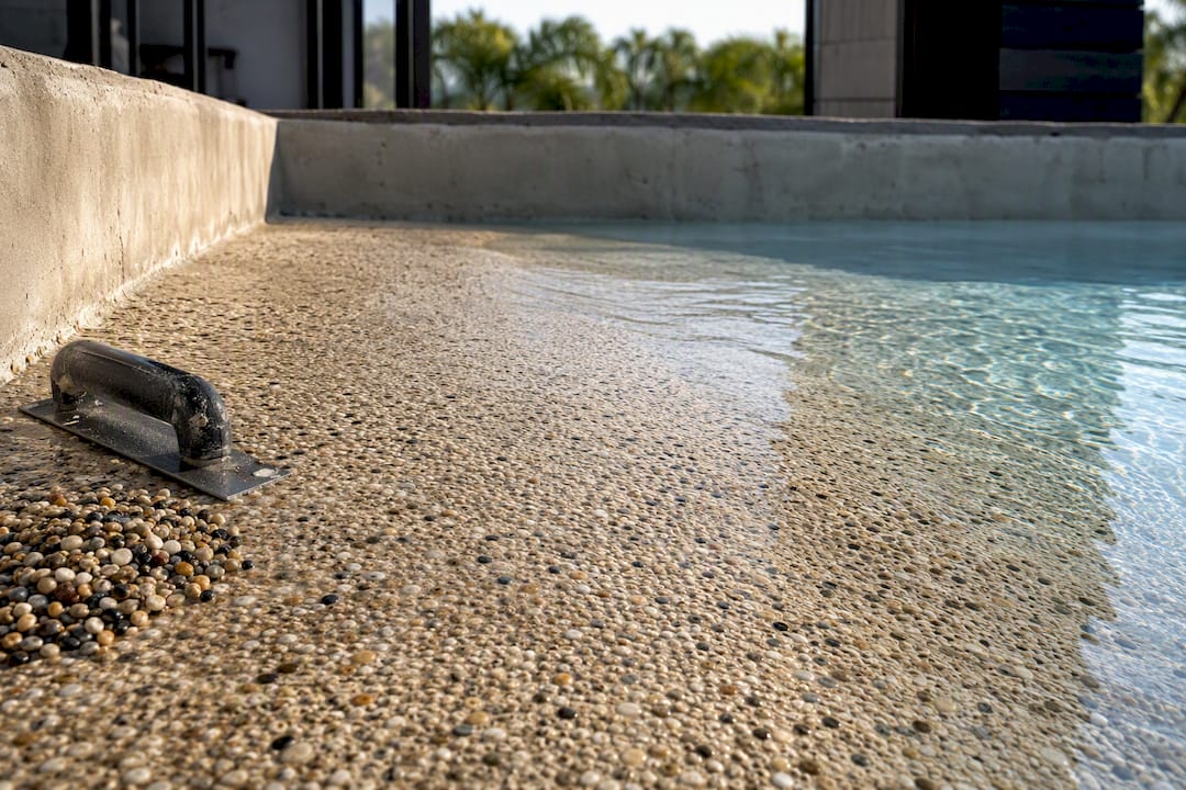 Textured aggregate finish on shallow pool ramp