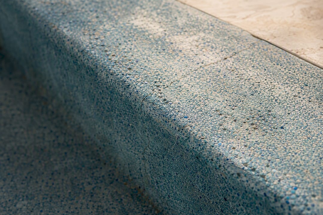 Worn quartz pool finish with pitting